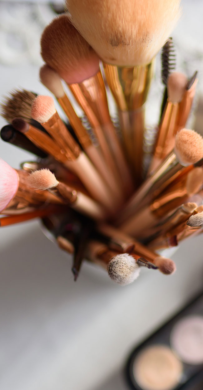 Austin Tx Makeup Services, A cup full of makeup brushes standing on end